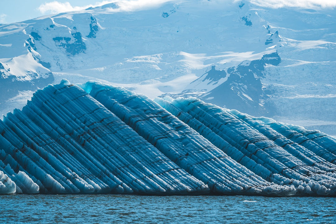 Large blue ice formation with a mountainous background