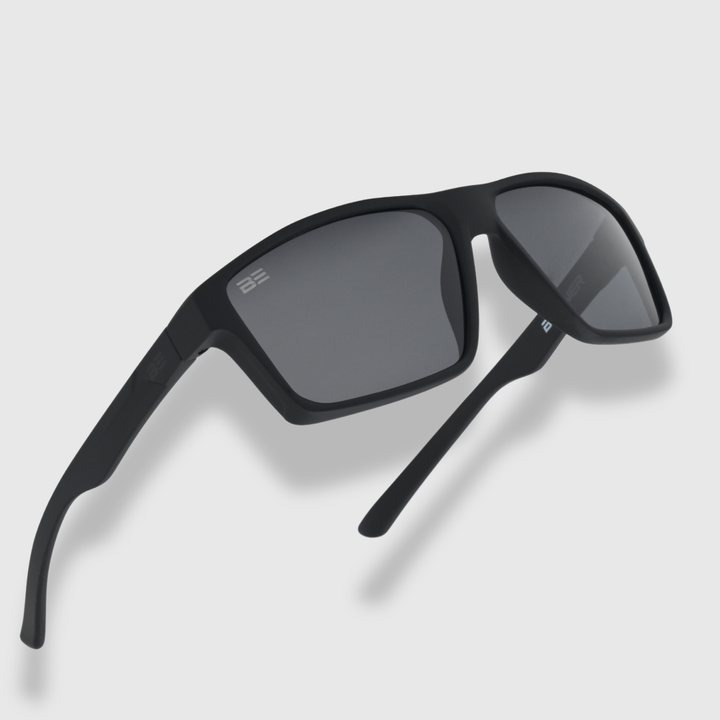 VALOR ONYX sunglasses with gray gradient lens on a light gray background