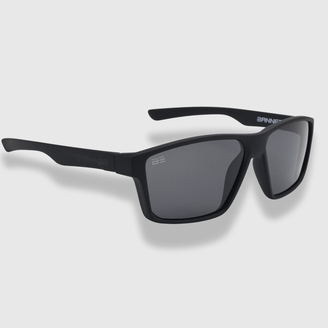VALOR ONYX sunglasses with gray gradient lens on a light gray background