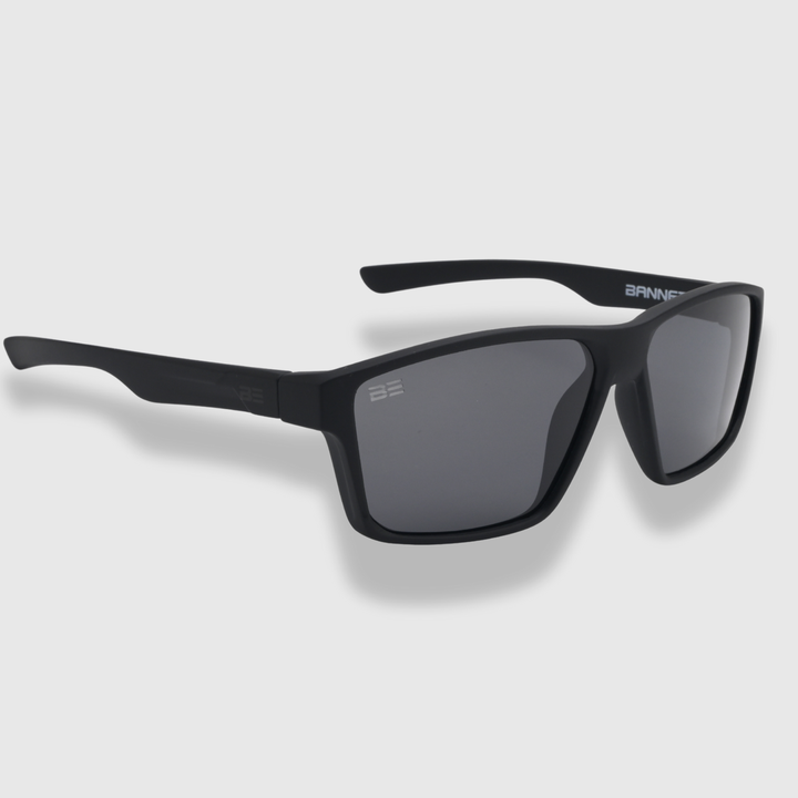 VALOR ONYX sunglasses with gray gradient lens on a light gray background