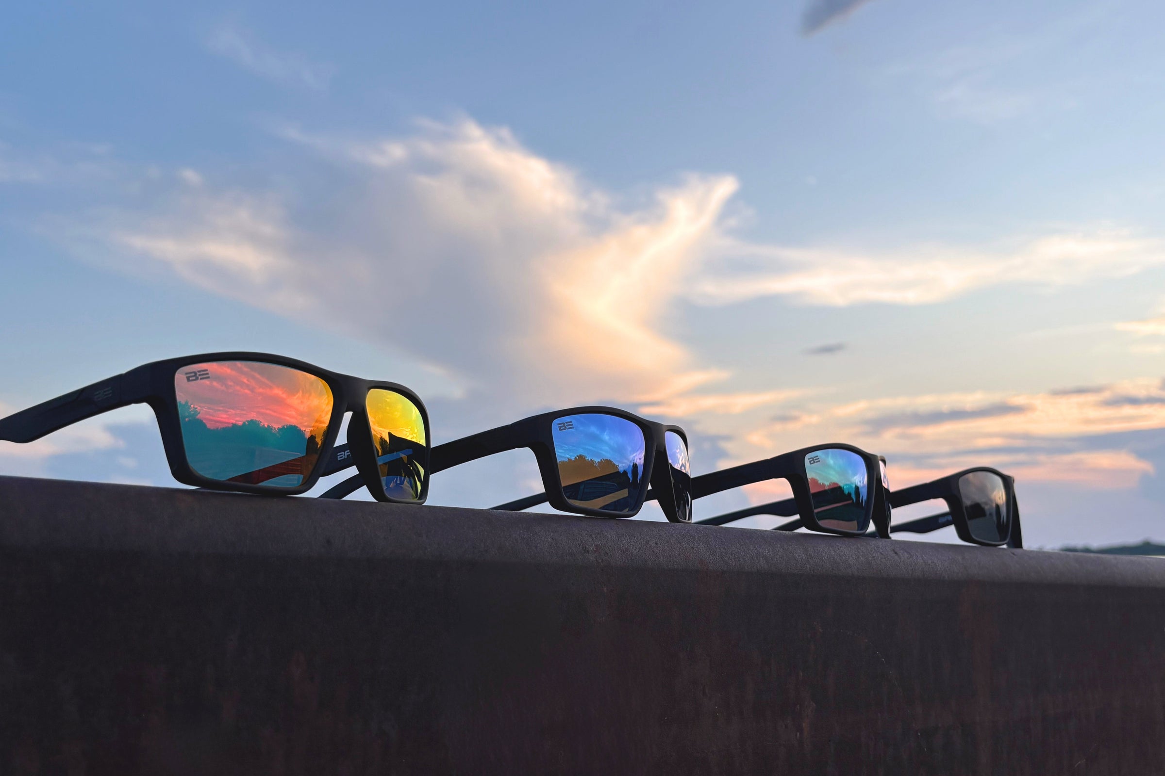 four sunglasses representing banner eyewear at sunset