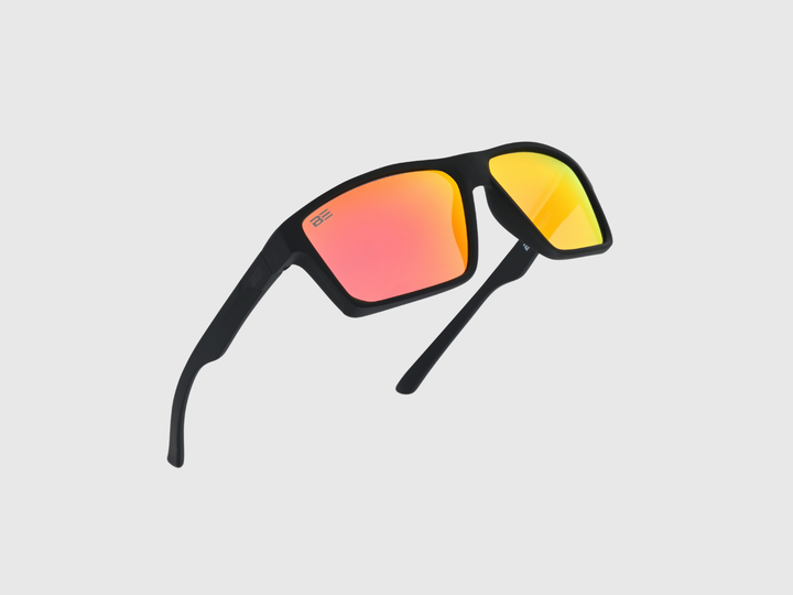 VALOR CRIMSON sunglasses with a red orange gradient lens on a light gray background
