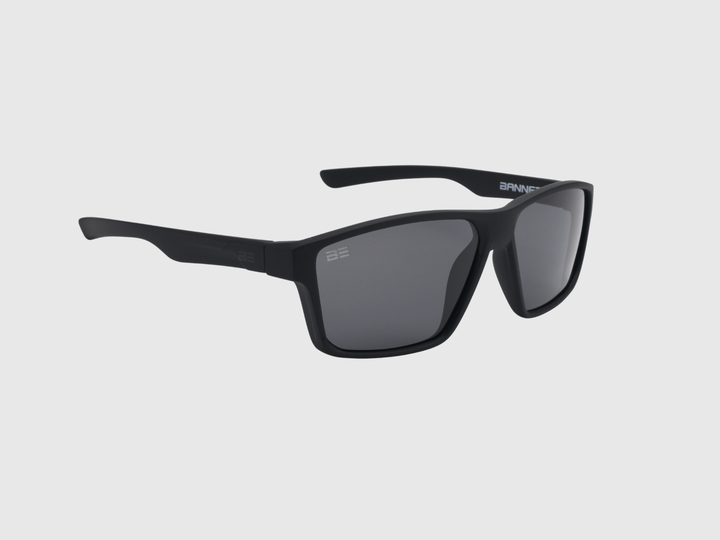 VALOR ONYX sunglasses with gray gradient lens on a light gray background