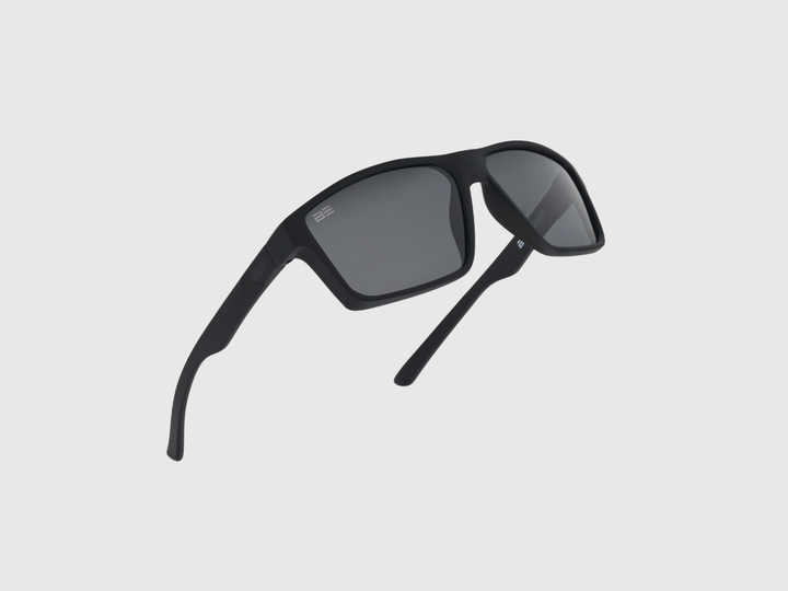 VALOR ONYX sunglasses with gray gradient lens on a light gray background
